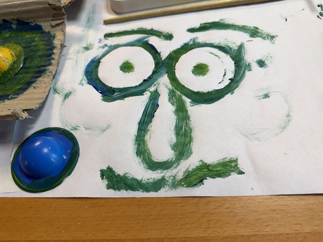 A painted face printed with bottle caps