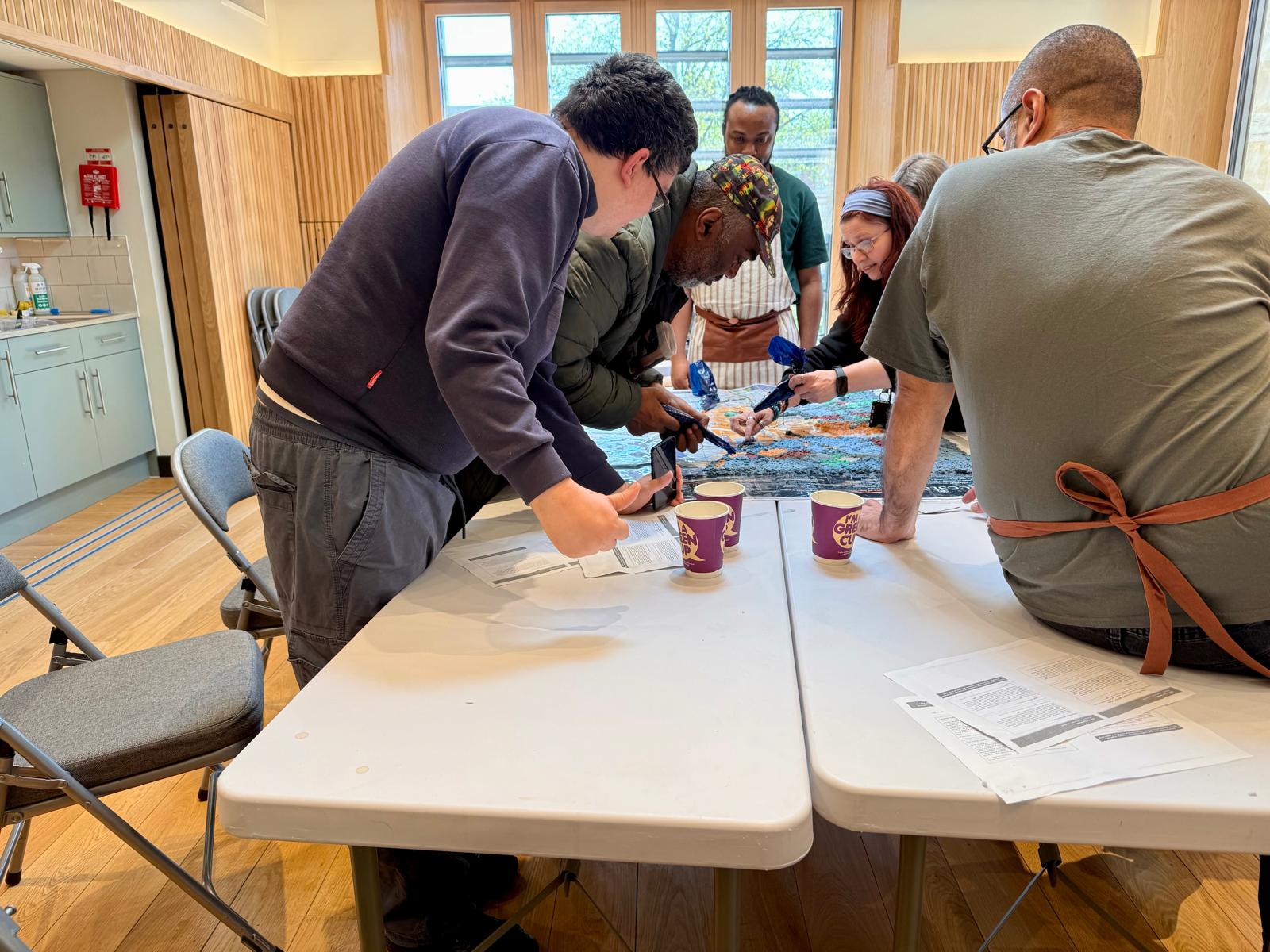 Participants at the first workshop in the Samworth Gallery, working around the printed map.